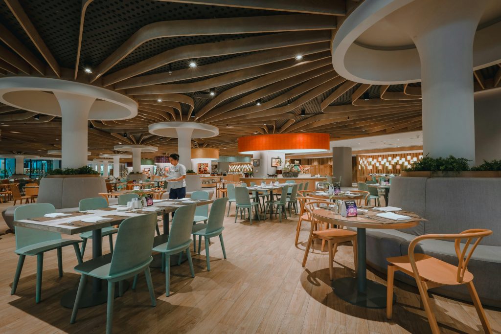 Contemporary restaurant interior showcasing elegant furniture and unique ceiling design.