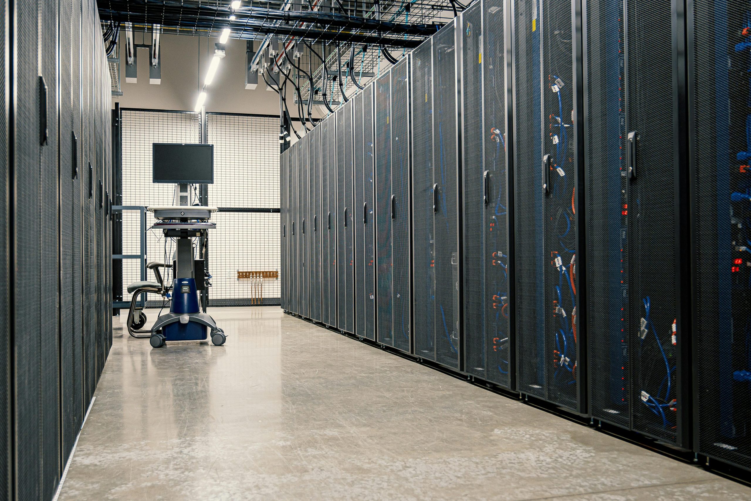 Cyber Liability Steel framework cabinets housing servers networking devices and cables in contemporary equipped data center